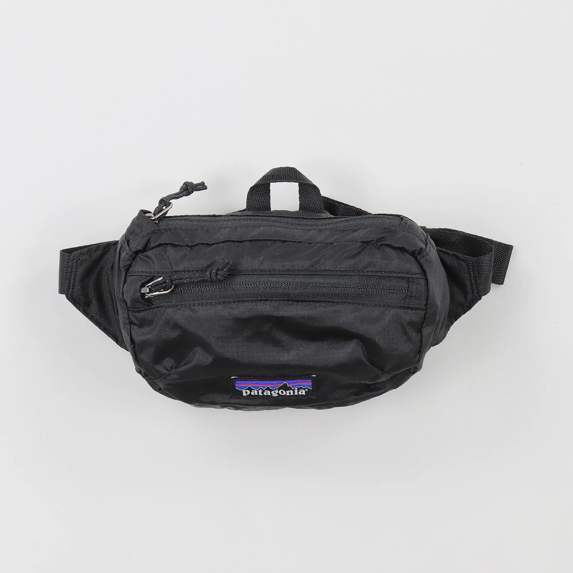 patagonia lightweight travel bum bag packable in black Tote Pack Worn Wear The adjustable waistband allows for a comfortable reach around the waist or hip Sling Bags, Hip Packs &